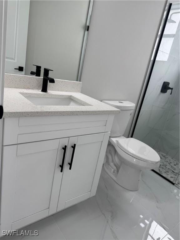 full bathroom with marble finish floor, toilet, vanity, and a marble finish shower