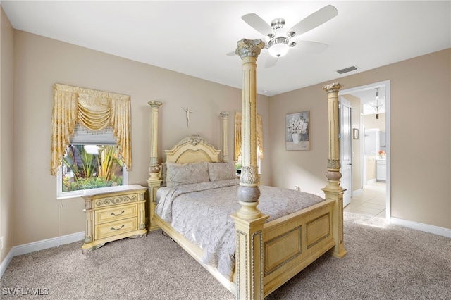 bedroom featuring light colored carpet, visible vents, ensuite bathroom, ceiling fan, and baseboards