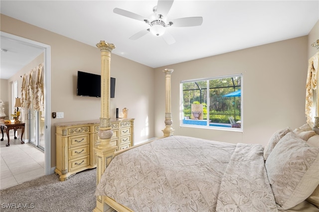 bedroom featuring light carpet, a ceiling fan, and light tile patterned flooring