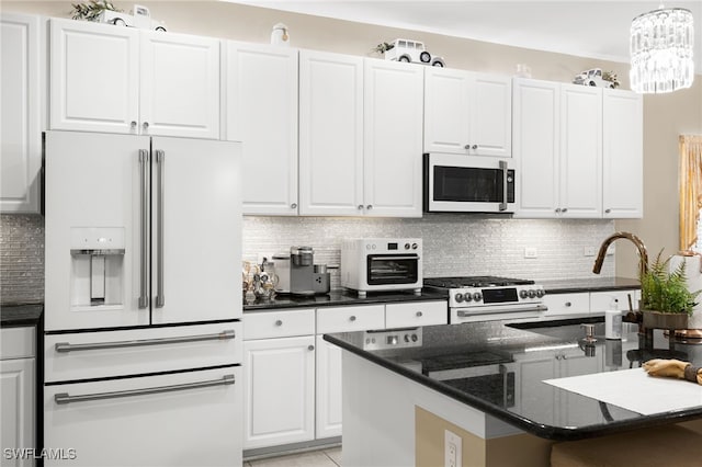 kitchen featuring white appliances and white cabinetry