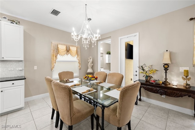 dining area featuring light tile patterned floors, baseboards, visible vents, and an inviting chandelier