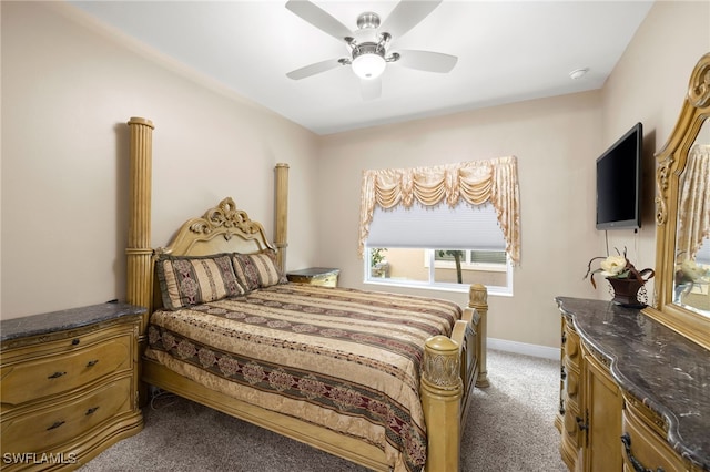 carpeted bedroom featuring baseboards and a ceiling fan