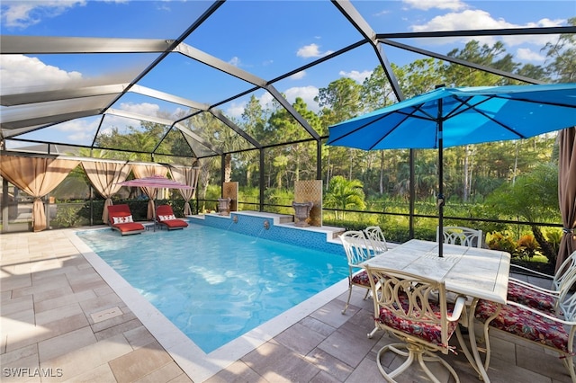 outdoor pool with a lanai and a patio