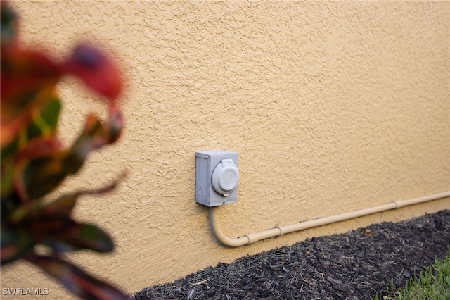 exterior details with electric meter and stucco siding