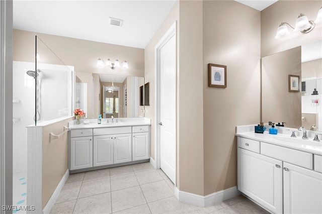 bathroom featuring a walk in shower, a sink, visible vents, and tile patterned floors