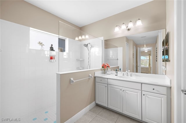 full bath featuring vanity, a walk in shower, and tile patterned floors