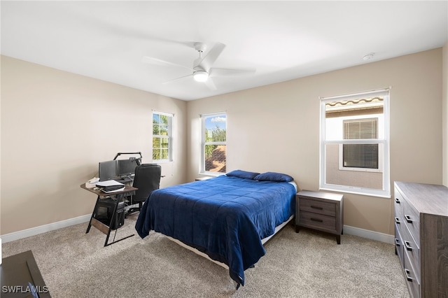 bedroom featuring baseboards, ceiling fan, and light colored carpet