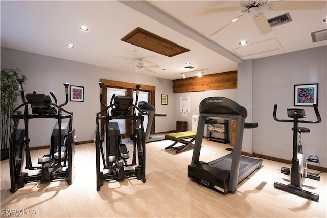 exercise room featuring ceiling fan and light wood-type flooring