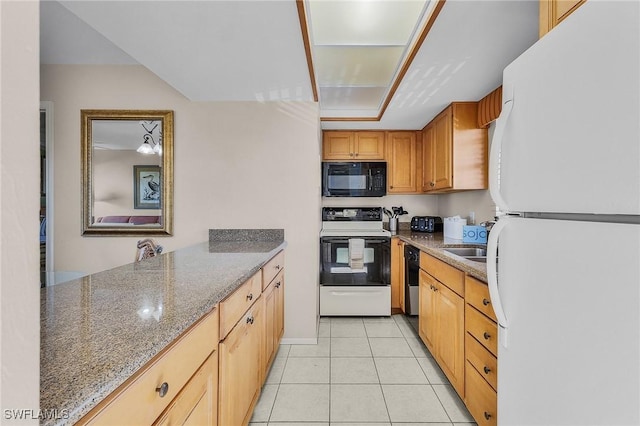 kitchen featuring sink, light tile patterned flooring, black appliances, and stone countertops