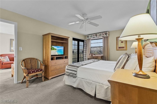 bedroom featuring carpet, ceiling fan, and french doors