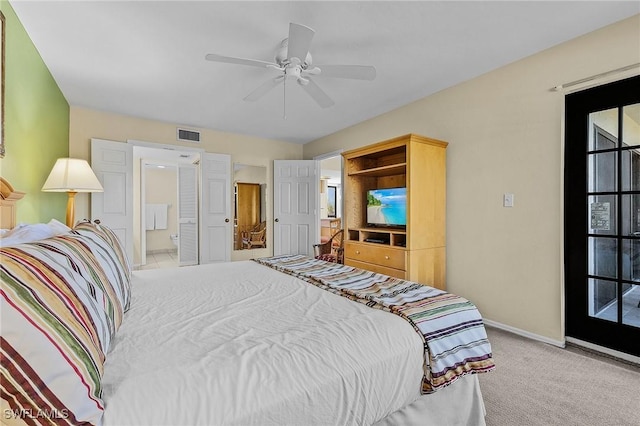 carpeted bedroom featuring ceiling fan and ensuite bathroom