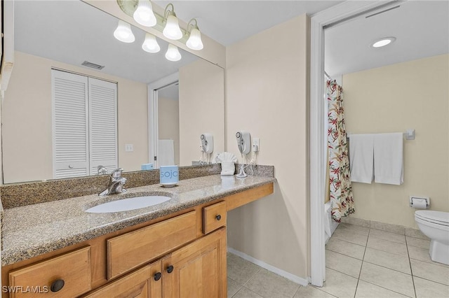 full bathroom with shower / tub combo with curtain, tile patterned floors, toilet, and vanity