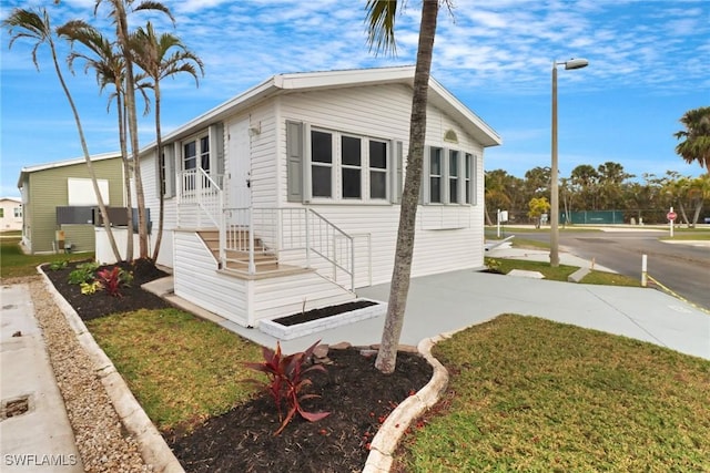 view of side of home featuring a lawn