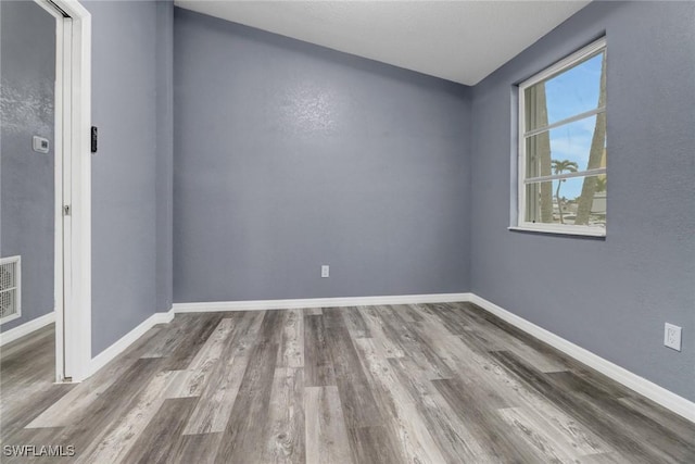 spare room featuring hardwood / wood-style floors