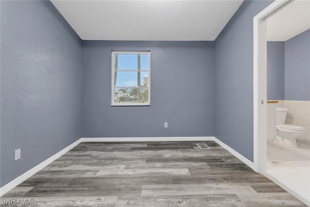 unfurnished room featuring hardwood / wood-style floors