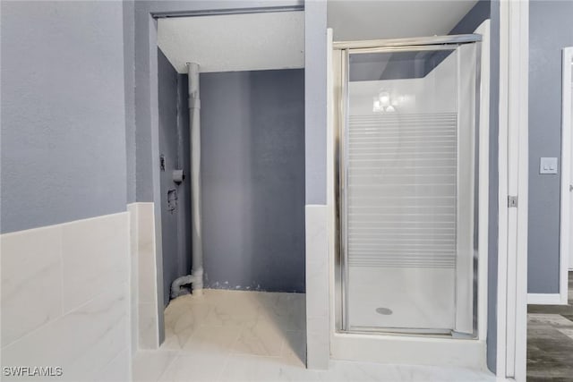 bathroom with a shower with door