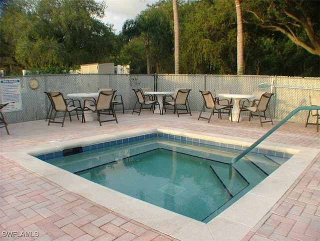 view of pool with a patio area and a community hot tub