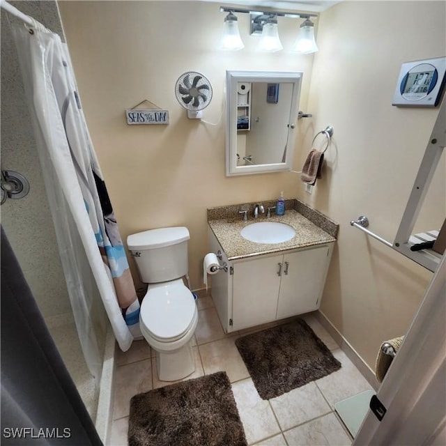 bathroom featuring a shower with curtain, tile patterned floors, vanity, and toilet