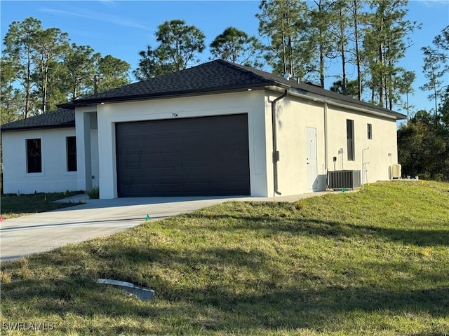 view of property exterior with a garage, a lawn, and central air condition unit