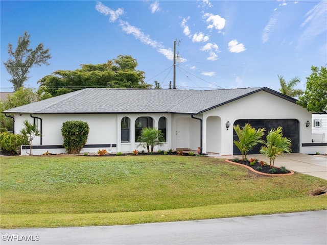 ranch-style house featuring a garage and a front yard