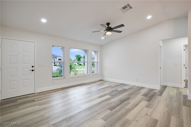 interior space featuring light hardwood / wood-style floors, lofted ceiling, and ceiling fan