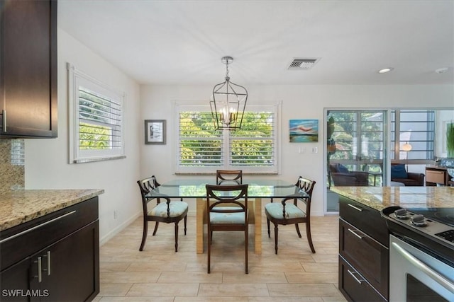 dining space featuring a chandelier