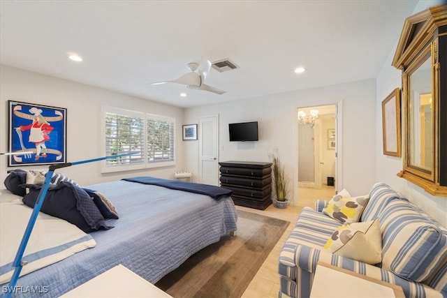 bedroom with light wood-type flooring, ensuite bath, and ceiling fan