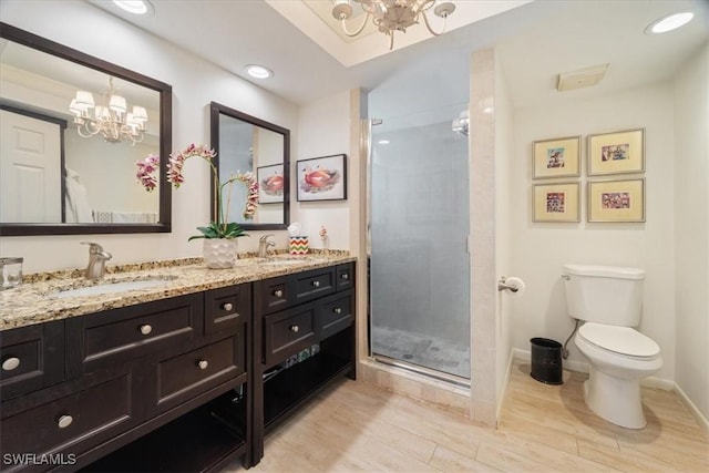 bathroom featuring vanity, toilet, a chandelier, and walk in shower