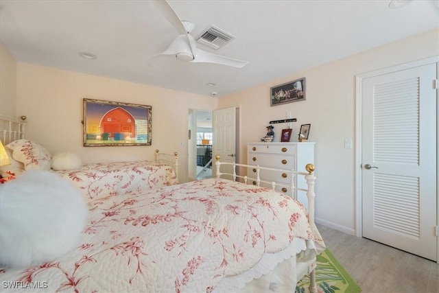 bedroom with light hardwood / wood-style floors and ceiling fan