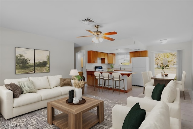 living room featuring ceiling fan and light tile patterned floors