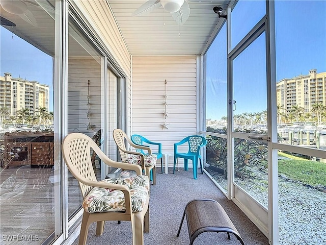 sunroom featuring ceiling fan