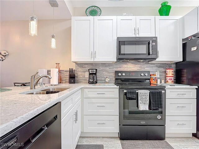 kitchen featuring white cabinetry, sink, backsplash, hanging light fixtures, and black appliances