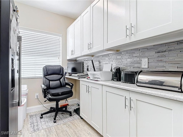 home office featuring light hardwood / wood-style flooring and a healthy amount of sunlight