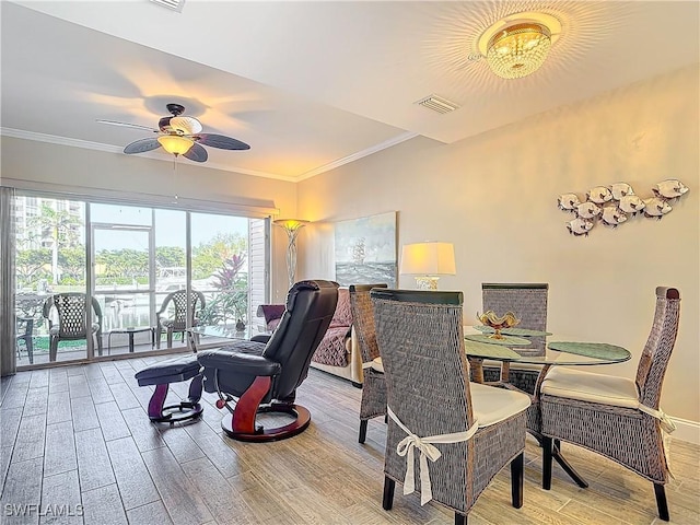 dining area featuring wood-type flooring, ornamental molding, and ceiling fan