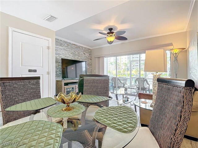 dining room with crown molding and ceiling fan