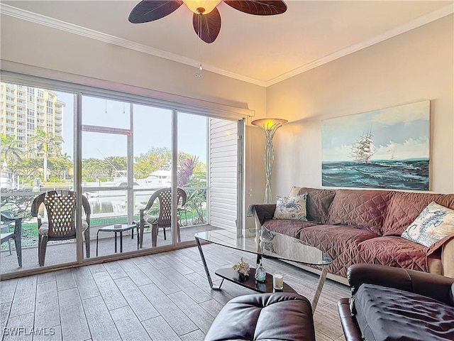 living room featuring hardwood / wood-style flooring, ceiling fan, and ornamental molding