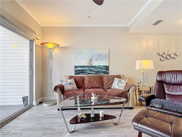 living room featuring crown molding and plenty of natural light