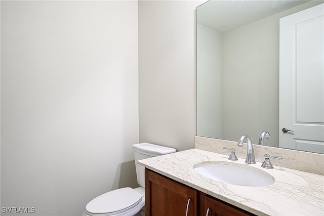 bathroom with toilet and vanity