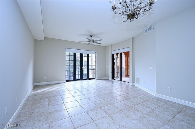 tiled empty room featuring ceiling fan and french doors