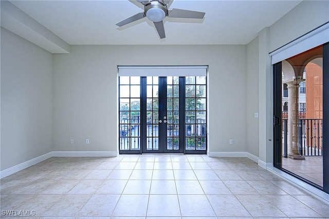 spare room with light tile patterned flooring, ceiling fan, and french doors