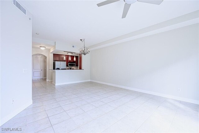 unfurnished living room with ceiling fan with notable chandelier and light tile patterned floors