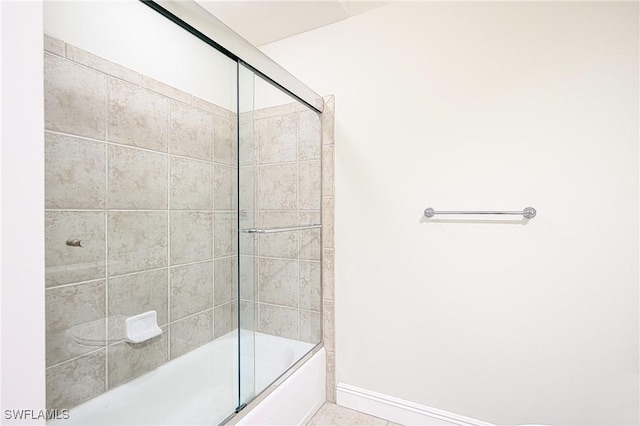 bathroom with bath / shower combo with glass door