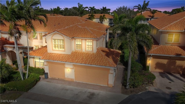 mediterranean / spanish-style home featuring a garage