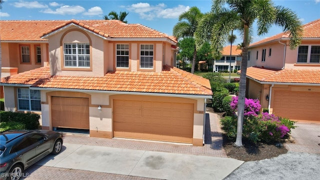 mediterranean / spanish-style house with a garage