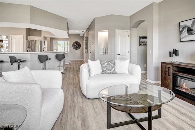 living room with sink and light wood-type flooring