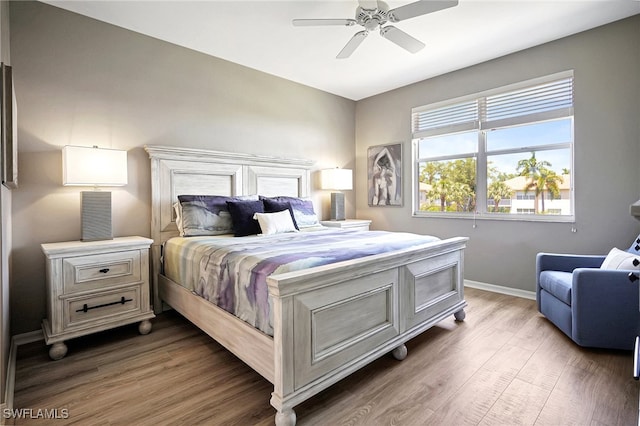 bedroom with dark hardwood / wood-style flooring and ceiling fan