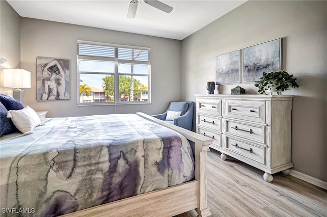 bedroom with light hardwood / wood-style floors and ceiling fan