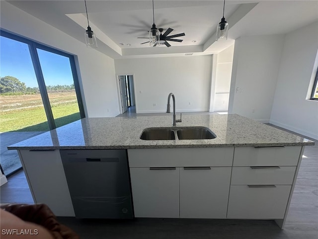 kitchen with sink, white cabinetry, black dishwasher, and light stone countertops