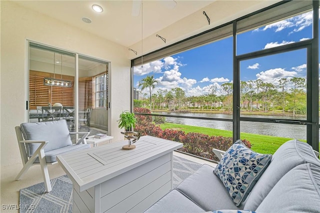 sunroom with a water view and a wealth of natural light