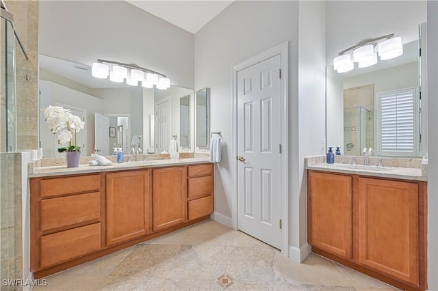 bathroom with an enclosed shower, vanity, and tile patterned flooring